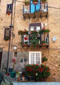 a building with flower boxes and balconies on it at Marianna in Isnello