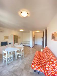 a living room with a table and a couch at Residence Luna in Lignano Sabbiadoro