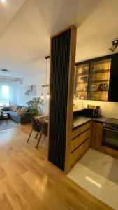 a kitchen and living room with a table and a couch at Apartment Unamare in Belgrade