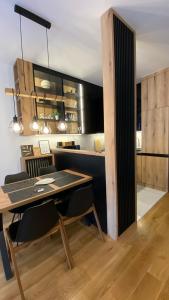 a kitchen with a table and a dining room at Apartment Unamare in Belgrade