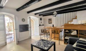 a living room with a table and chairs and a tv at Old town STONE HOUSE OASIS in Selce