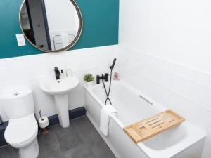 uma casa de banho com um lavatório, um WC e um espelho. em Ramsgate Boutique Apartment em Ramsgate