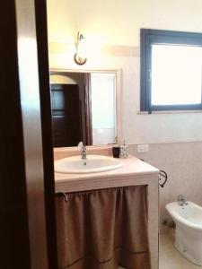 a bathroom with a sink and a mirror at Casa Rustikò in Marsala