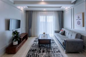 a living room with a couch and a tv at Lavermo Hotel Apartments in Kampala