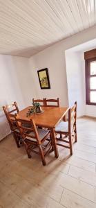 a wooden dining room table with chairs at Casa Ines in Ricobayo