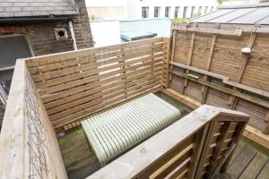 an empty garden with a bench on a balcony at Stylish Apt - Newly refurbished - Private Terrace in London