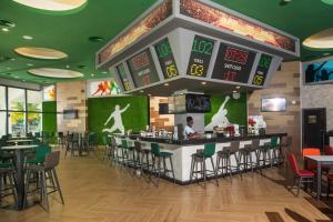 a restaurant with a bar and tables and chairs at Riu Ocho Rios - All Inclusive in Ocho Rios