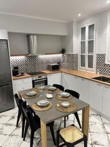 a kitchen with a table and chairs in it at Central44 Luxury Apartment Ermou in Athens