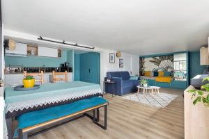 a room with a bed and a living room at Appartement 56m2 avec terrasse au calme & borne électrique in Dardilly