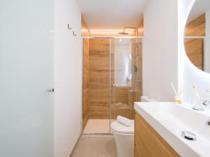 a bathroom with a shower and a toilet and a sink at Shabolo Apartments Las Palmas in Las Palmas de Gran Canaria