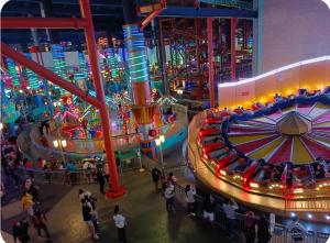an indoor carnival exhibit with a ferris wheel and people at First World Hotel 第一大酒店 in Genting Highlands