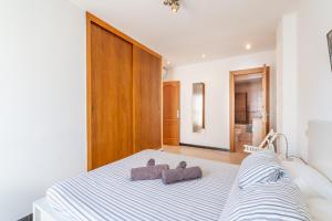 a bedroom with a bed with two towels on it at Can Marineta in Palma de Mallorca
