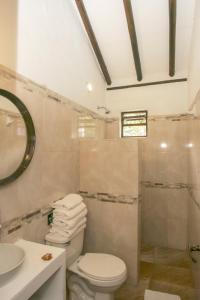 e bagno con servizi igienici, lavandino e doccia. di Hacienda Flamingo a Villa de Leyva