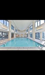 a large swimming pool in a large building at Spacious 2 Bedroom plus Den, 2 Bath, Sleeps 5 with Balcony and Lakeview Downtown Toronto Condo in Toronto