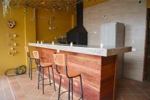 a kitchen with a bar with stools and a stove at Apartamento Piedecuesta in Piedecuesta +10 photos