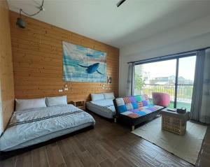 a bedroom with a bed and a couch at Come Home Travel in Tainan