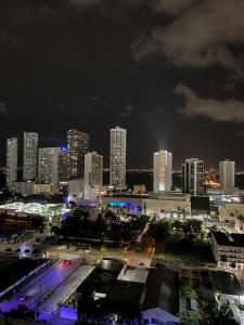 a city skyline at night with tall buildings at Canvas in Miami