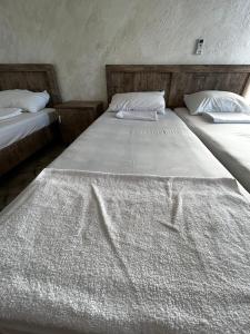 Una cama o camas en una habitación de Отель «JIMA”