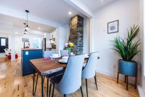 a dining room with a wooden table and chairs at The Downtown Nordic Nest in St. John's