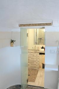 a kitchen with a white refrigerator and a sink at Brezza Marina Ortigia in Siracusa