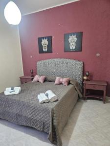a bedroom with a bed with two towels on it at A casa di Livia in Villabate +18 photos