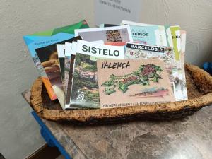 a basket filled with books on top of a table at Casa da Benda in Estorãos