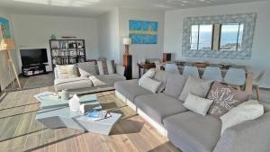 a living room with a couch and a table at Villa Paradise Vue Mer Golfe de Saint Tropez 8 couchages in Les Issambres