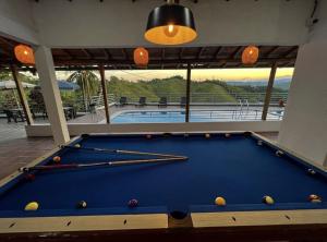 a pool table in a room with a swimming pool at La Manola Finca Hotel in Doradal