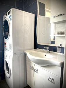 a bathroom with a washing machine and a sink at Casa Orsini Vista Mare -Manfredi Homes&Villas in Manfredonia