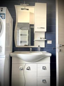 a bathroom with a sink and a mirror at Casa Orsini Vista Mare -Manfredi Homes&Villas in Manfredonia +21 photos