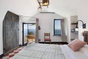 a bedroom with a bed and a view of the ocean at Agriturismo Bricco in Finale Ligure