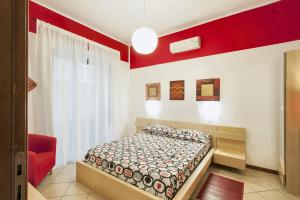 una camera con letto e parete rossa di One bedroom apartement with balcony and wifi at Palermo a Palermo