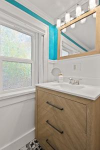 a bathroom with a sink and a window at Bohemian Bungalow Pac-Man, walk downtown, pet friendly in Columbia