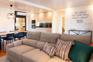 a living room with a couch and a kitchen at Caniçada House - Gerês in Vieira do Minho