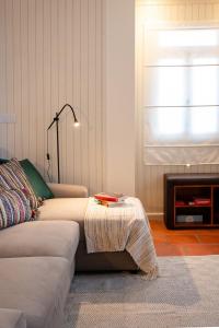 a living room with a couch and a table at Caniçada House - Gerês in Vieira do Minho