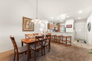a dining room and kitchen with a table and chairs at Ozark Comfort Condo in Branson West