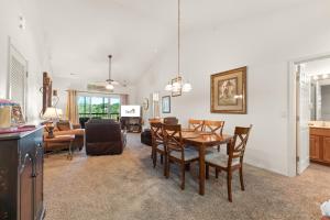 a dining room and living room with a table and chairs at Ozark Comfort Condo in Branson West