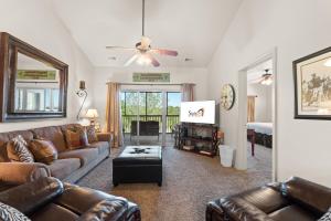 a living room with a couch and a tv at Ozark Comfort Condo in Branson West +44 photos