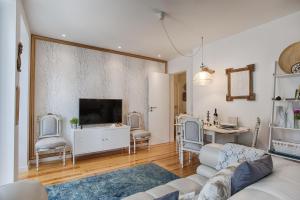 a living room with a couch and a tv at BmyGuest - 28 Tram Central Apartment in Lisbon