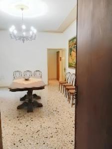 a room with a table and chairs and a chandelier at 2 bedrooms apartement with enclosed garden at Vita in Vita