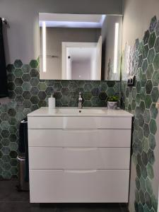 a bathroom with a white sink and a mirror at Experiencia Premium en la Esencia de Denia in Denia +30 photos
