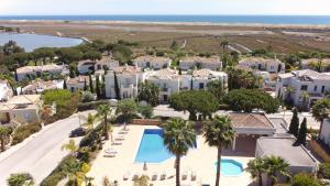 an aerial view of a resort with a swimming pool at White Sunset Villa in Quinta do Lago