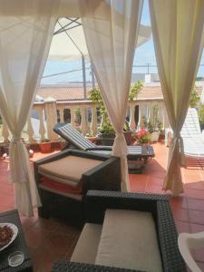 a patio with two beds on a porch at 2 bedrooms apartement with sea view furnished terrace and wifi at Pianoconte 2 km away from the beach in Piano Conte