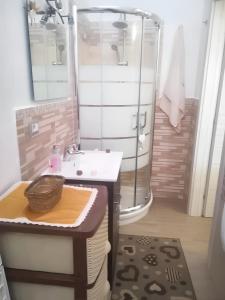 a bathroom with a sink and a shower at 2 bedrooms apartement with sea view furnished terrace and wifi at Pianoconte 2 km away from the beach in Piano Conte