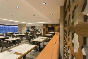 a restaurant with tables and chairs and a large window at Fesa Business Hotel in Gebze