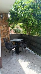 een zwarte tafel en stoelen op een patio bij Apartments Borić in Cres