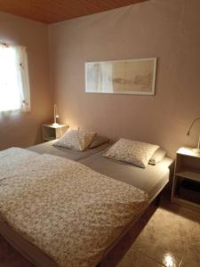 a bedroom with two beds and a lamp and a window at Casa-Molino in Tuineje