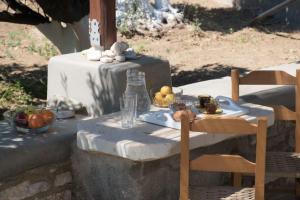 a table with a plate of fruit on it at Rokombo House Tinos in Tinos