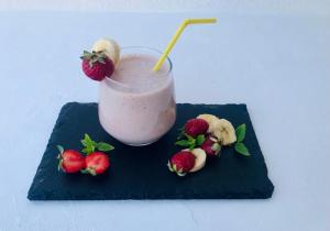 a drink on a blue plate with strawberries andilantro at Morpheus Rooms in Kinion