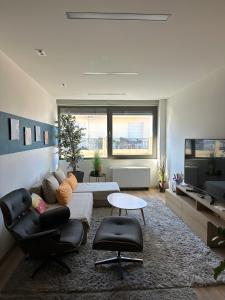 a living room with a couch and a tv at URBAN APARTMENT in Amaliás